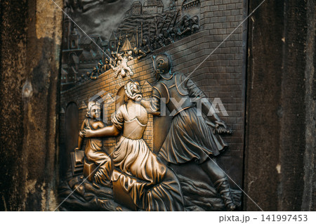 Bronze relief detail on the statue of St. John of Nepomuk Bronze relief detail on the statue of St. John of Nepomuk 141997453