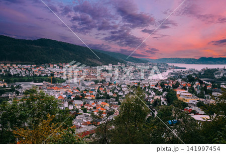 Panoramic view of Bergen cityscape under a pink sunset sky. Panoramic view of Bergen cityscape under a pink sunset sky. 141997454