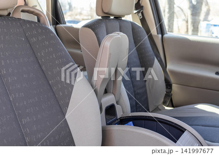 Folded center armrest and fabric upholstery inside a car cabin, representing vehicle comfort features, modular design, and interior ergonomics for modern automotive travel trips 141997677