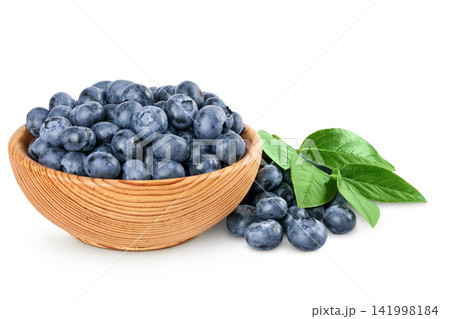blueberry in wooden bowl isolated on white background 141998184