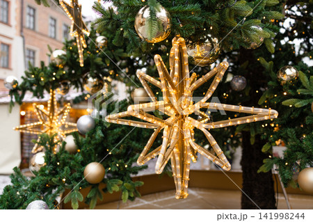Decorated Christmas tree branches with golden ornaments in Krakow 141998244