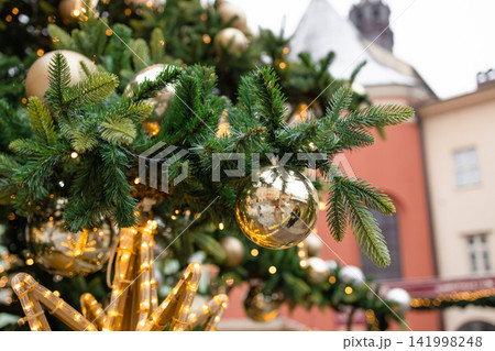 Decorated Christmas tree branches with golden ornaments in Krakow 141998248