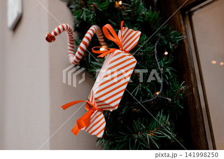 Christmas wreath decoration with red and white candy gift wrap Christmas wreath decoration with red and white candy gift wrap 141998250