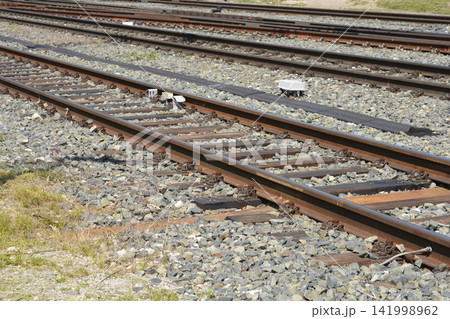 Multiple parallel railway tracks with gravel ballast background Multiple parallel railway tracks with gravel ballast background 141998962