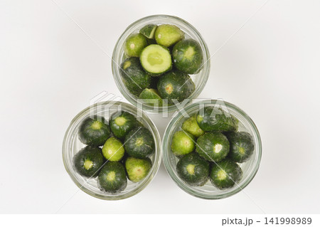 Three glass jars filled with sliced green gherkin cucumbers Three glass jars filled with sliced green gherkin cucumbers 141998989