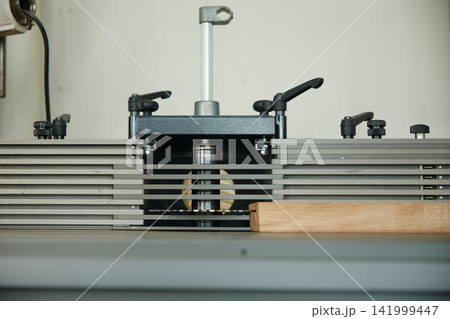 Detailed view of router in action during cabinet manufacturing process with safety measures Detailed view of router in action during cabinet manufacturing process with safety measures 141999447