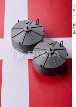 Liquefied gas storage tanks set against the Danish money as a background for your design 142000127