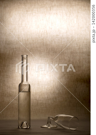 Still life with a glass bottle and a broken wine glass Still life with a glass bottle and a broken wine glass 142000356