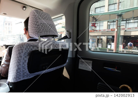 Interior of a Japanese taxi with driver and protective partition Interior of a Japanese taxi with driver and protective partition 142002913