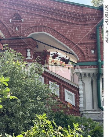 Red brick structure featuring ornate architectural details and a staircase surrounded by lush greenery leading to the entrance area Red brick structure featuring ornate architectural details and a staircase surrounded by lush greenery leading to the entrance area 142003830