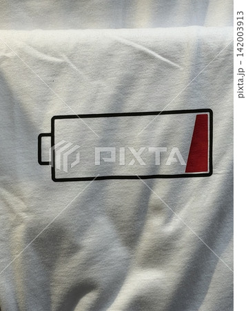 Battery icon graphic design displayed on white fabric, showcasing a low charge indicator with a red section and black outline for clarity Battery icon graphic design displayed on white fabric, showcasing a low charge indicator with a red section and black outline for clarity 142003913