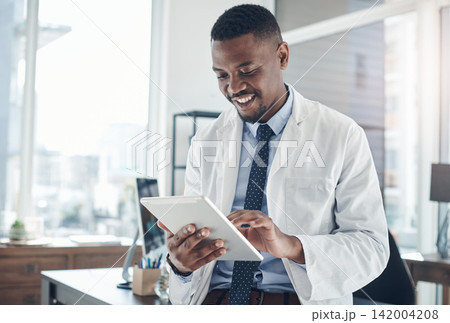 Office, black man and doctor with tablet, smile and telehealth for clinic, serious and online for healthcare. Workplace, hospital and internet and technology for science, medical and research 142004208