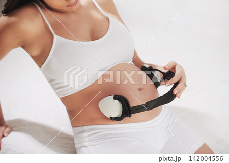 Pregnant, stomach and listening to music with headphones so baby relax to sound in womb for brain development. Pregnancy, belly and streaming audio to calm fetus with lullaby in home with mother Pregnant, stomach and listening to music with headphones so baby relax to sound in womb for brain development. Pregnancy, belly and streaming audio to calm fetus with lullaby in home with mother 142004556