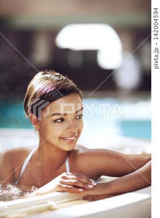 Woman, hot tub and spa relax at resort with smile thinking for stress relief, holiday or travel. Female person, jacuzzi and hotel in Miami with summer hospitality or lodge trip, rest or hydrotherapy Woman, hot tub and spa relax at resort with smile thinking for stress relief, holiday or travel. Female person, jacuzzi and hotel in Miami with summer hospitality or lodge trip, rest or hydrotherapy 142004594