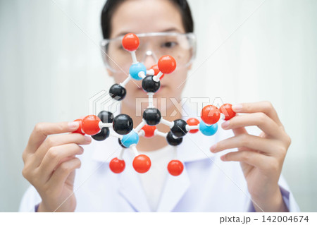 Scientist holding molecular model for chemical technology. Scientist holding molecular model for chemical technology. 142004674