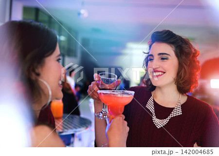Party, friends and toast with cocktail drink at pub together for celebration, event or happy hour at night club. Cheers, girls and women with alcohol glass at bar for social gathering, rave and flare Party, friends and toast with cocktail drink at pub together for celebration, event or happy hour at night club. Cheers, girls and women with alcohol glass at bar for social gathering, rave and flare 142004685