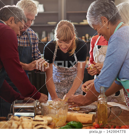 Cooking, class and chef with group in kitchen learning recipe for wellness, nutrition and health. Restaurant, culinary skills and men and women with ingredients, dough and food for dinner or baking 142004778