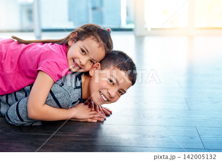 Floor, playing and portrait of children in home for sibling bonding, relax and fun together. Family, happy . and young girl and boy for childhood, youth and playful on holiday, weekend and vacation Floor, playing and portrait of children in home for sibling bonding, relax and fun together. Family, happy . and young girl and boy for childhood, youth and playful on holiday, weekend and vacation 142005132