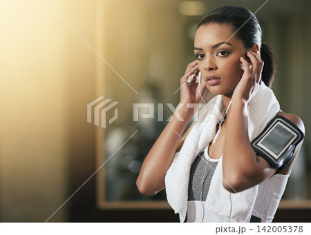Woman, earphones and exercise arm band or cellphone pouch or fitness app, music or song. Female person, listening and digital wellness or gym podcast for health workout or audio, online or training 142005378