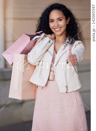 Woman, thumbs up and shopping bag in city with portrait, smile and excited for deal, sale or discount. Girl, happy and sign for yes, like and review of customer experience on metro sidewalk in Mexico Woman, thumbs up and shopping bag in city with portrait, smile and excited for deal, sale or discount. Girl, happy and sign for yes, like and review of customer experience on metro sidewalk in Mexico 142005597
