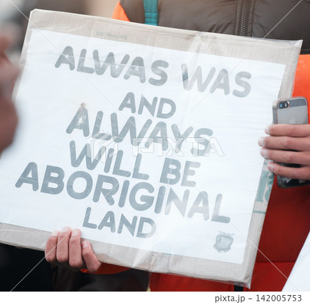 Person, protest and aboriginal with support, march and sign with demands, human rights and freedom. Cardboard, holding paper and indigenous with group in street, Australia and event for justice 142005753