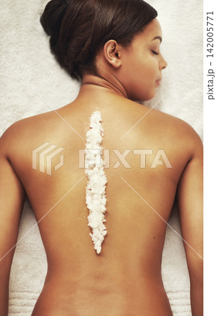 Woman, back and salt scrub in spa for skincare, wellness and natural detox or self care. Female person, body and cosmetics treatment in beauty salon for healthy skin, exfoliate and massage or relax 142005771