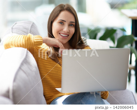 Smile, laptop and portrait of woman on sofa watching funny movie, film or show in living room together. Laughing, happy and female person streaming comedy video online with computer in lounge at home Smile, laptop and portrait of woman on sofa watching funny movie, film or show in living room together. Laughing, happy and female person streaming comedy video online with computer in lounge at home 142006045