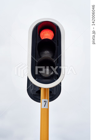 Stop. Lights, stop and grey sky in urban area for speed control, safety and robot in the city. Traffic, metal and red light outdoor for direction, caution and sign on road for destination and drive. Stop. Lights, stop and grey sky in urban area for speed control, safety and robot in the city. Traffic, metal and red light outdoor for direction, caution and sign on road for destination and drive. 142006046