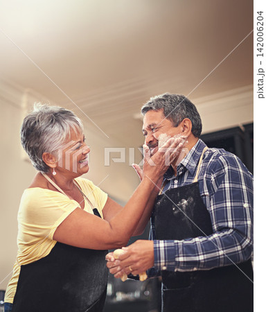 Senior, couple and flour in kitchen, fun and bonding in home, morning and pancakes for breakfast. Happiness, old man and woman in house, marriage and love with care, cooking and together for food Senior, couple and flour in kitchen, fun and bonding in home, morning and pancakes for breakfast. Happiness, old man and woman in house, marriage and love with care, cooking and together for food 142006204