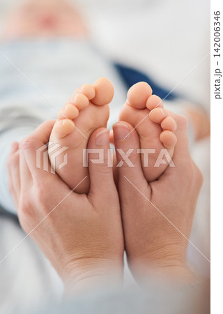Mommy, baby and toes for love in home, security and support in bonding for wellness or trust. Mother, toddler and care for maternity or relax on bed, child development and comfort for single mom 142006346