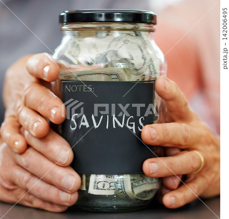 Married hands, money and mason jar for insurance, retirement or savings plan. Senior couple, cash or bills for pension, banking or investing together and generational wealth opportunity for family 142006495