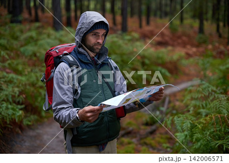 Search, map and man lost in forest with guide to camp in woods or thinking of navigation or direction. Confused, travel and trekking in nature with backpack or plan to find location on hiking journey Search, map and man lost in forest with guide to camp in woods or thinking of navigation or direction. Confused, travel and trekking in nature with backpack or plan to find location on hiking journey 142006571