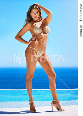 Bikini, model and body in summer for luxury, fashion and style in Greece for holiday at pool. Female person, portrait and swimwear at poolside for island vacation, tropical and designer clothes. Bikini, model and body in summer for luxury, fashion and style in Greece for holiday at pool. Female person, portrait and swimwear at poolside for island vacation, tropical and designer clothes. 142006598