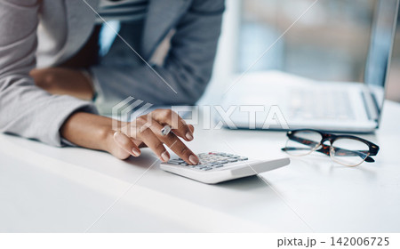 Woman, hands and laptop with calculator for finance, budget planning or accounting at office. Closeup of female person, accountant or employee counting numbers for financial profit or audit on desk Woman, hands and laptop with calculator for finance, budget planning or accounting at office. Closeup of female person, accountant or employee counting numbers for financial profit or audit on desk 142006725