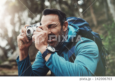 Nature, camera and man in forest for photography, travel and hiking, journey or memory. Jungle, backpack and mature wildlife photographer with digital lens for adventure, explore or outdoor discovery 142006763