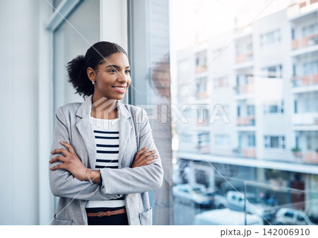 Crossed arms, thinking and business black woman by window with confidence, company pride and startup ideas. Professional, opportunity and person with ambition for career, job and working in office 142006910