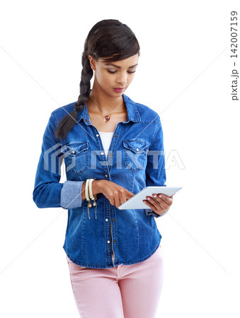 Girl, typing and tablet in studio for fashion news, trends and update on cool style on white background. Person scroll, reading or surfing internet on digital tech for online magazine or clothes tips Girl, typing and tablet in studio for fashion news, trends and update on cool style on white background. Person scroll, reading or surfing internet on digital tech for online magazine or clothes tips 142007159
