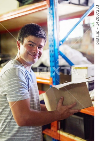 Man, portrait and boxes in garage for moving with investment in real estate, new house and home. Property, delivery and person with smile or cardboard for storage, cargo and package order security 142007233