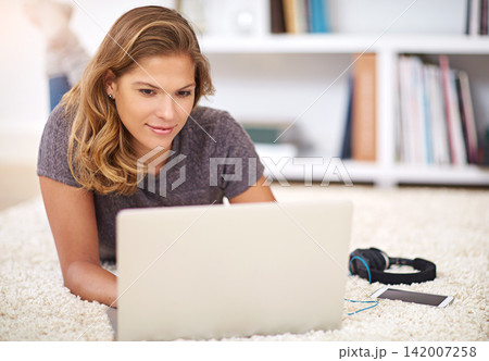 Relax, streaming or woman on laptop on carpet to chill with internet connection for film, video or movie online. Ground, break and girl on social media, blog and technology for subscription in home 142007258