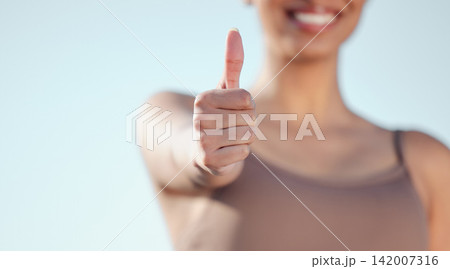 Woman, hand and fitness with thumbs up for winning, thank you or success on a blue sky background. Closeup of female person or athlete with like emoji, yes sign or ok for approval, review or feedback Woman, hand and fitness with thumbs up for winning, thank you or success on a blue sky background. Closeup of female person or athlete with like emoji, yes sign or ok for approval, review or feedback 142007316