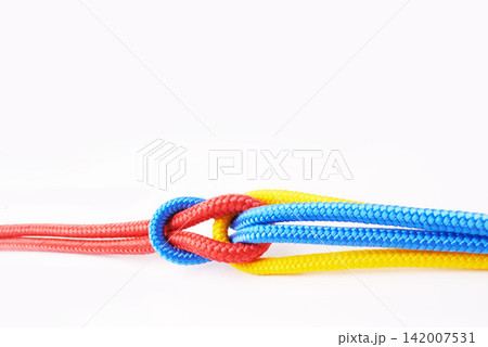 Colourful, ropes and tied for together in studio to represent unity, connect and trust. Secure, string and reef knotted for security to stop movement of objects safety on isolated white background Colourful, ropes and tied for together in studio to represent unity, connect and trust. Secure, string and reef knotted for security to stop movement of objects safety on isolated white background 142007531