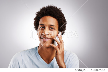 Phone call, smile and man in studio with mockup for gossip, news or web communication on grey background. Smartphone, listen and African model with networking chat, voice or streaming app connection Phone call, smile and man in studio with mockup for gossip, news or web communication on grey background. Smartphone, listen and African model with networking chat, voice or streaming app connection 142007583