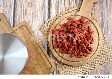 Dried goji berries on a wooden tray in a kitchen Dried goji berries on a wooden tray in a kitchen 142007723