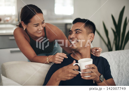 Relax, smile and couple on couch with coffee, bonding and happy relationship together in home on weekend. Morning drink, man and woman on cozy sofa with laughing, talking and love in calm apartment. Relax, smile and couple on couch with coffee, bonding and happy relationship together in home on weekend. Morning drink, man and woman on cozy sofa with laughing, talking and love in calm apartment. 142007749