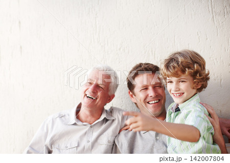 Pointing, family and grandpa, father and child in home for bonding, happy relationship and generations. Wall background, smile and grandfather, boy and dad relaxing in garden with view on weekend Pointing, family and grandpa, father and child in home for bonding, happy relationship and generations. Wall background, smile and grandfather, boy and dad relaxing in garden with view on weekend 142007804