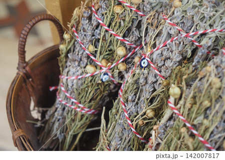 Dried herbs tied with red and white string in a basket Dried herbs tied with red and white string in a basket 142007817