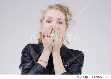 Surprise, gossip and portrait of woman in studio for fake news, announcement or mistake with worry. Shock, emotion and person with hands on mouth for wow, omg or wtf expression by gray background. Surprise, gossip and portrait of woman in studio for fake news, announcement or mistake with worry. Shock, emotion and person with hands on mouth for wow, omg or wtf expression by gray background. 142007900