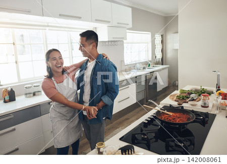 Dancing, cooking and couple in kitchen together with healthy food, relationship and bonding in home. Romance, happy man and woman in apartment with nutrition, care and meal prep with love for lunch 142008061