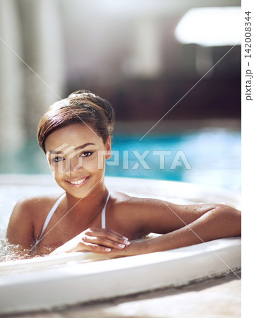 Portrait, woman and relax with smile in pool on holiday, break and luxury or mindfulness. Female person, jacuzzi and happy or satisfied on vacation, trip and travel at hotel or resort for swimming 142008344