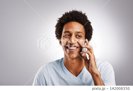Phone call, smile and happy man in studio with mockup for gossip, news or web communication on grey background. Smartphone, listen and African model with networking, chat or streaming app connection 142008350